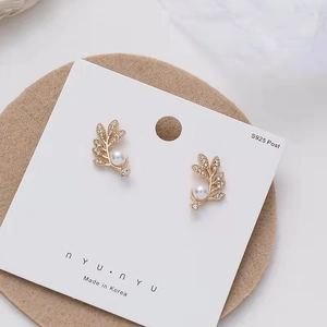 Detail of leaf-shaped earrings with pearls and micro-pave cubic zirconia stones