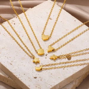 Detail of six-piece gold stainless steel necklace set with geometric pendants