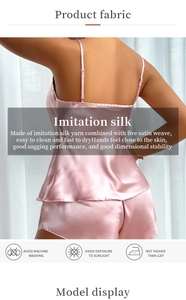 Pink silk satin pajama set with spaghetti straps and wavy hem detail on shorts