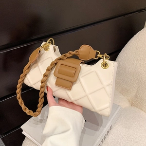 Chic white quilted baguette bag with brown woven shoulder strap and gold hardware buckle