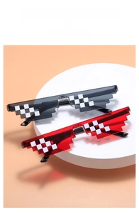 Close-up of black and red pixelated mosaic sunglasses on a white display stand