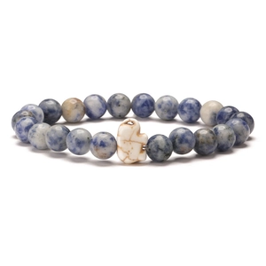 Detail of blue spotted sodalite beads and white accent stone on elastic elephant bracelet