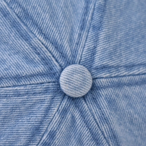 Nahaufnahme des oberen Knopfes und der Sechs-Panel-Nahtdetails der Denim-Baseballkappe