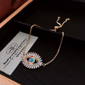 Detail of vintage evil eye bracelet in gold finish with colorful zircon stones