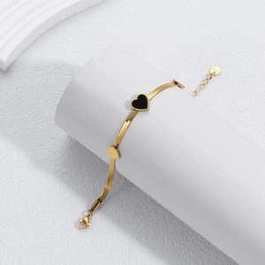 Elegant gold-plated stainless steel snake chain bracelet with black and gold heart charms