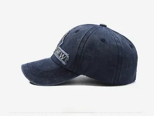 Detail of navy blue washed cotton baseball cap featuring side patch embroidery and distressed edge