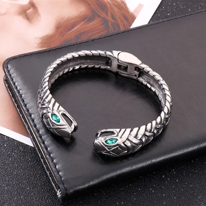 Double headed snake cuff bracelet in silver stainless steel with green gemstone eyes