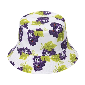 Close-up of a white reversible bucket hat featuring a purple cartoon grape pattern print