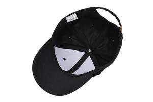 Detail view of cotton baseball cap interior with 100% cotton label and metal buckle