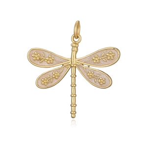 Macro detail of golden dragonfly pendant with pink enamel wings and flower patterns