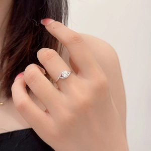Artistic eye-shaped 0.5ct moissanite ring in 925 sterling silver on model finger