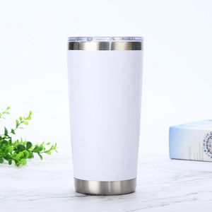 20oz white vacuum insulated stainless steel tumbler on marble with green plant