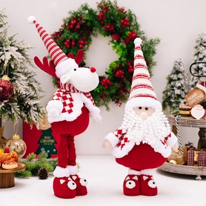 Detail of plush Santa and reindeer figurines with red and white striped hats for Christmas
