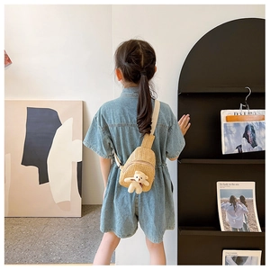Kids woven straw chest bag featuring a cute plush bear on a khaki crossbody pack