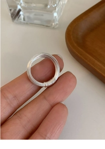 Detail of multi-layer geometric silver ring showing fine wire texture and craftsmanship