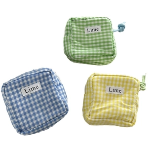 Three-piece set of mini plaid canvas pouches in blue green and yellow with lime label