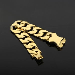 Detailed view of heavy gold Cuban link chain with unique bone-shaped clasp closure