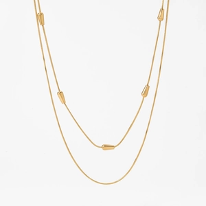 Elegant gold double layer snake chain necklace featuring polished teardrop metal pendants