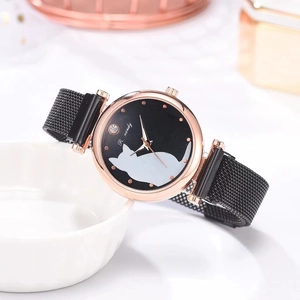Close-up of rose gold watch featuring a black dial with a white cat silhouette and crystal