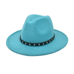Detail of teal wool fedora hat featuring black band with silver metal rivet studs