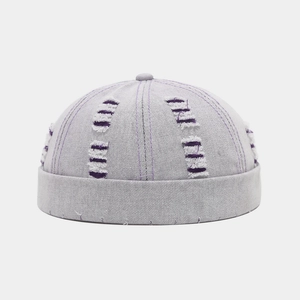Detailed close-up of light purple Miki Hat with distressed torn fabric and top button