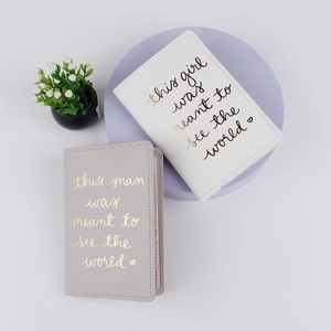 Minimalist PU leather passport covers in white and gray with gold embossed travel quotes