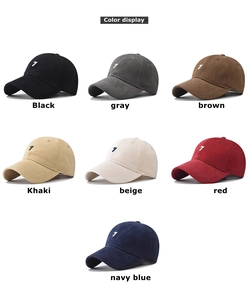 Detailed view of 7 embroidered cotton baseball caps in multiple colors on white background