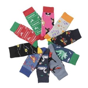 Multiple colorful crew socks with cartoon patterns like reindeer and corgis on white background