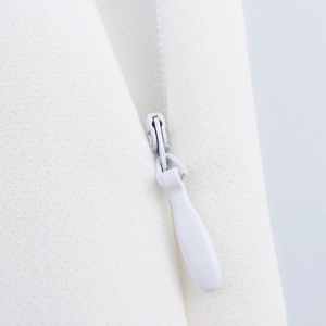 Close-up of high-quality white invisible zipper on professional woven fabric