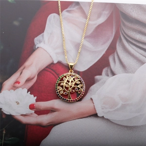Detail of life tree pendant with colorful stones on gold box chain necklace