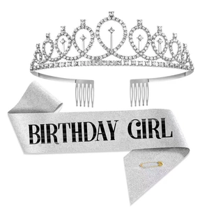 Close-up of silver rhinestone crown and Birthday Girl glitter sash with safety pin