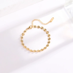 Minimalist gold titanium steel bracelet featuring textured circular links on white background