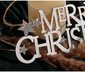 Close-up of silver glitter Merry Christmas hanging sign with stars and rustic twine