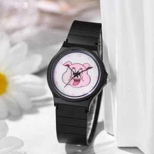 Macro detail of kids analog watch featuring black strap and pink cartoon pig dial pattern