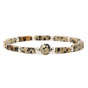 Detailed macro view of square spotted stone beads with silver spacers on beaded bracelet