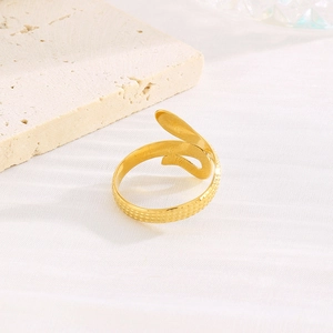 Macro detail of gold-plated snake pattern ring with textured mesh surface