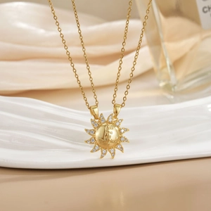 Detail of sun-shaped pendant necklace with cubic zirconia and You Are My Sunshine engraving