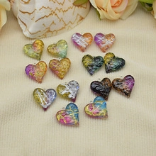 Macro shot of assorted heart-shaped resin pendants with gold foil for DIY jewelry