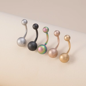 Close-up of matte and polished stainless steel belly rings in five different metallic colors