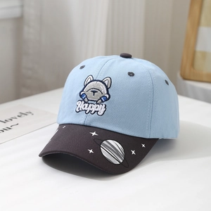Close-up of children baseball cap with blue crown, brown brim and cartoon dog embroidery