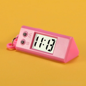 Macro view of pink triangle digital clock with LCD display and hanging hook