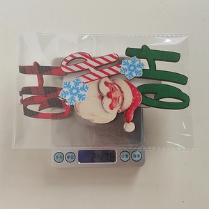 Detailed view of Christmas Ho Ho Ho toppers and Santa tags packaged in a clear bag