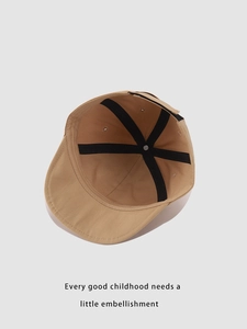 Detail view of khaki cotton baseball cap interior with adjustable strap and inner seams