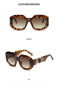 Detail view of leopard print sunglasses with brown gradient lenses and gold accents