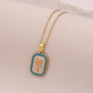 Detail of gold palm tree pendant with blue enamel frame on a delicate link chain