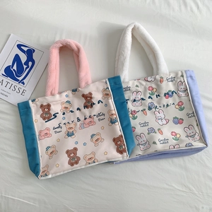 Detail of canvas tote bags with plush handles, cartoon bear and rabbit prints