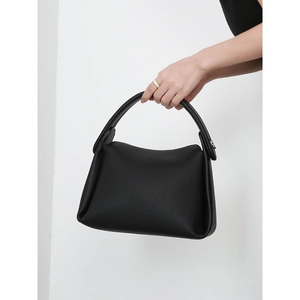 Minimalist large black leather pillow bag with lychee texture and top handle strap