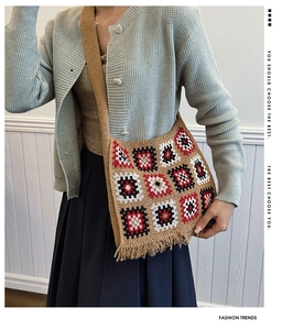 Detail of bohemian knit crossbody bag featuring colorful geometric squares and fringe