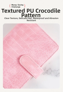 Pink crocodile pattern A6 binder with money saving challenge text on marble surface