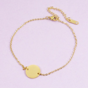 Minimalist gold stainless steel bracelet with a round mirror-polished pendant and lobster clasp